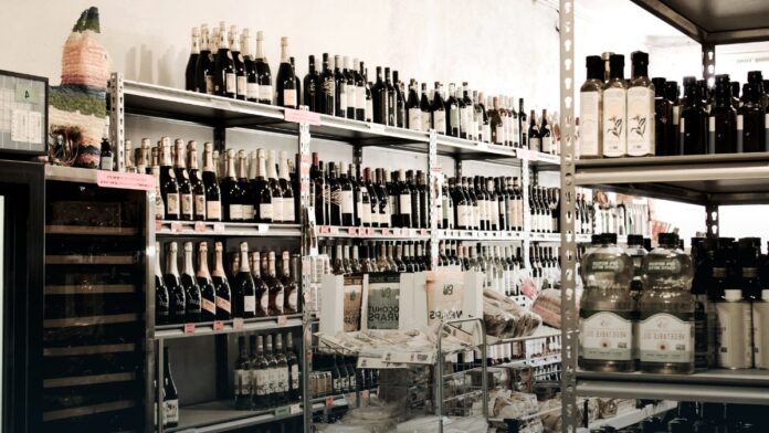 A supermarket aisle lined with wine and spirits bottles. A supermarket aisle lined with wine and spirits bottles.