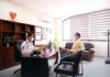 Contingency Management: Strong Evidence, Constrained Payment An empty clinical consulting room with a desk and chairs, representing the outpatient settings where contingency management programmes are delivered.