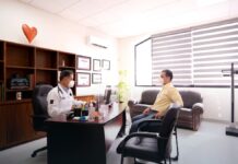 Contingency Management: Strong Evidence, Constrained Payment An empty clinical consulting room with a desk and chairs, representing the outpatient settings where contingency management programmes are delivered.
