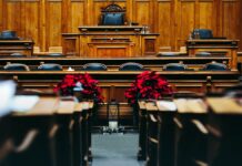 Two Thirds of States Can Charge an Overdose Death as Homicide. Half the Defendants Are Friends and Family. The interior of a wood-panelled courtroom with empty benches.