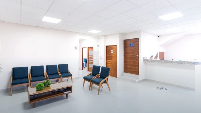 A bright, empty medical waiting room with rows of modern seating, representing residential treatment capacity paid for through state Medicaid programs.