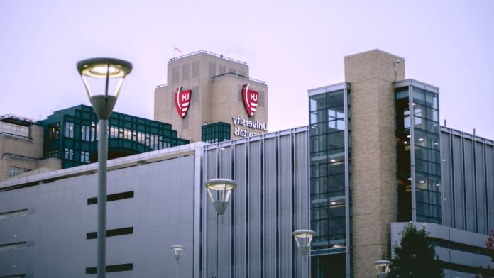 The exterior of a hospital building seen from the street, representing the clinic based settings where opioid treatment programs dispense methadone.