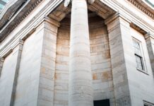 Opioid Settlement Money Passed 50 Billion Dollars. Tracking How It Is Spent Is Still Hard. The stone facade and columns of a historic American civic building.