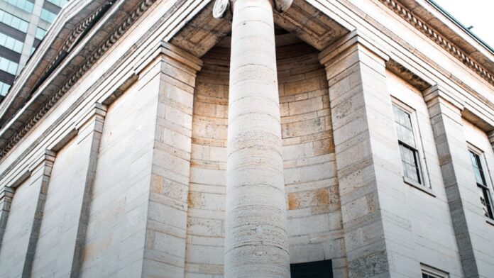 The stone facade and columns of a historic American civic building.