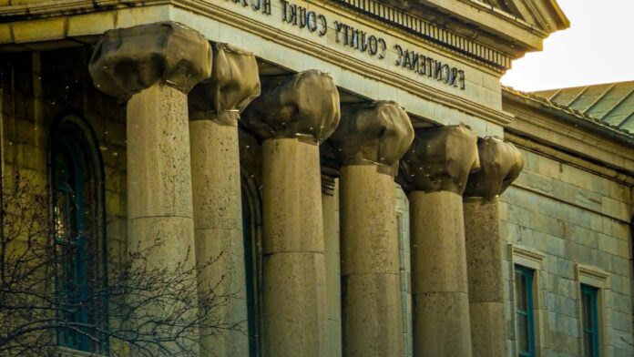 A courthouse exterior, representing the litigation that produced the national opioid settlements now being paid out to state and local governments.
