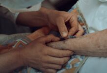 The Overdose Decline Is Real. It Has Not Reached Everyone Equally. A healthcare worker giving an injection to an older adult patient in a clinical setting.