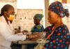 Syringe Programs Have Thirty Years of Evidence. Federal Funding Just Narrowed Again. A healthcare worker checking a patient blood pressure at a community health site.