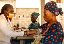 Syringe Programs Have Thirty Years of Evidence. Federal Funding Just Narrowed Again. A healthcare worker checking a patient blood pressure at a community health site.