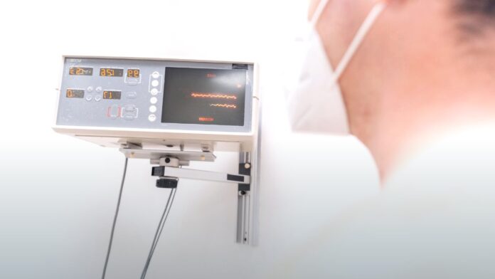 An electrocardiogram trace displayed on a monitor in a clinical setting.