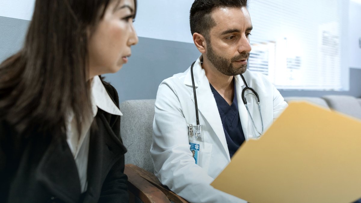 A clinician examining a patient during a medical appointment.
