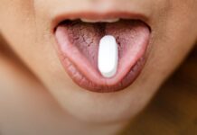 Counterfeit Pills: Why You Cannot Tell by Looking A close view of loose tablets held in an open palm.