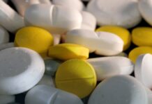 Marijuana Edibles: Why the Delay Causes So Many Overdoses A hand holding a small item over a plain kitchen surface.