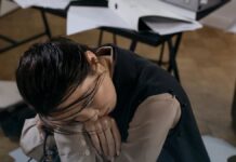 Methamphetamine Effects on the Brain and Body: What Recovers and What Does Not A person sitting with head lowered, appearing exhausted and unwell.