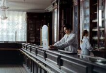 Naloxone: How It Works, How Long It Lasts, and What It Does Not Cover A pharmacist at a counter with medication shelves behind them.